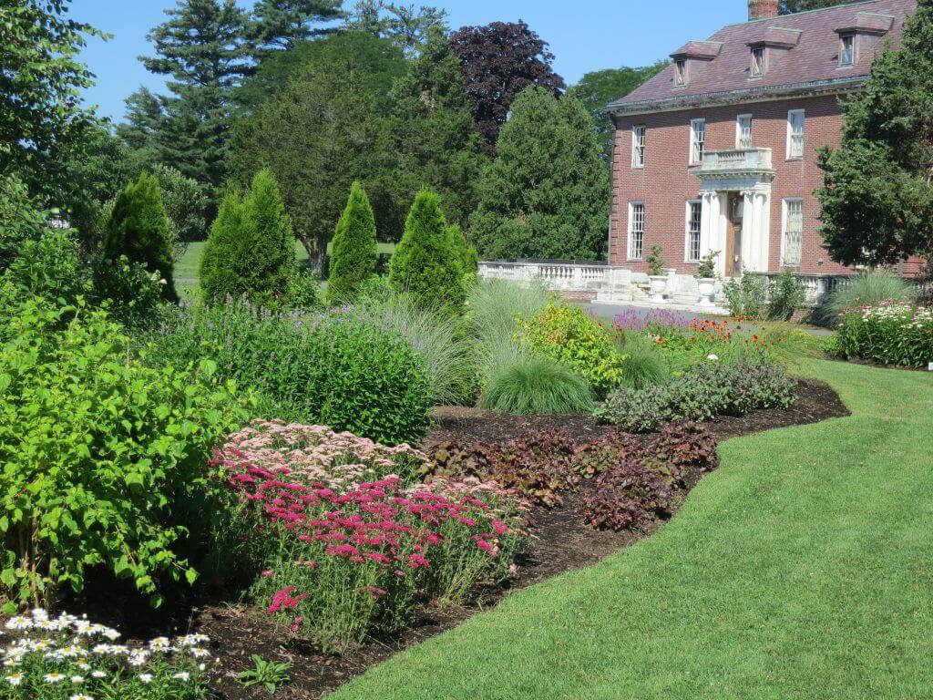 A wide view of the Bressingham Garden, showcasing its diverse collection of perennials and shrubs.